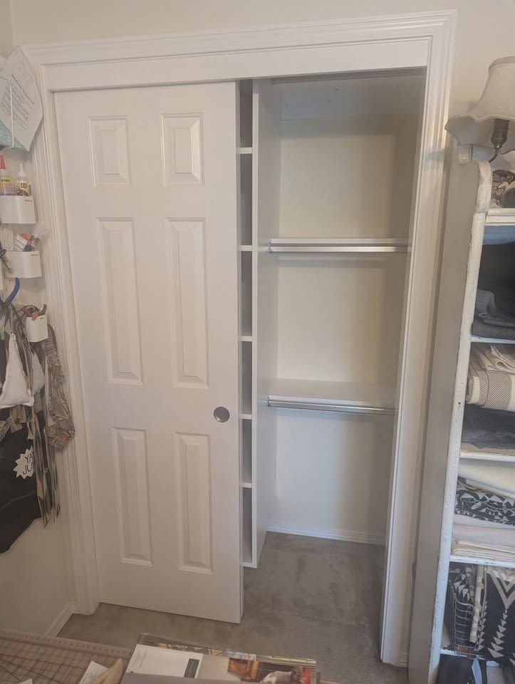 White craft closet, hanging side, with the bypass door open