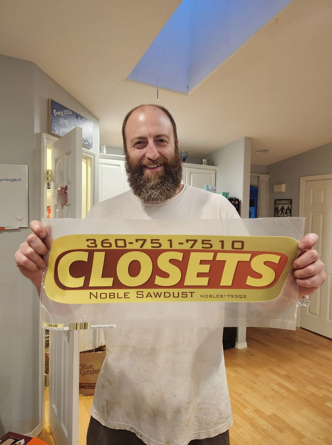 Curt holding the Noble Sawdust Closets sign