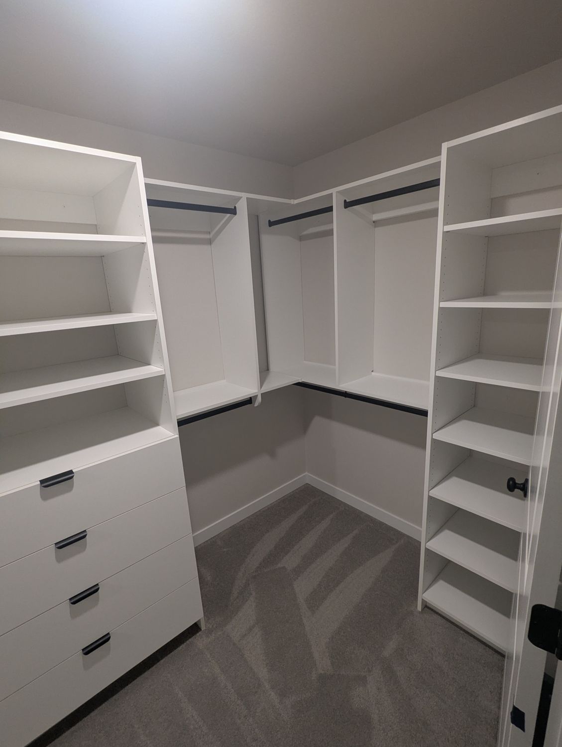 White closet with a drawer stack and tall shelving