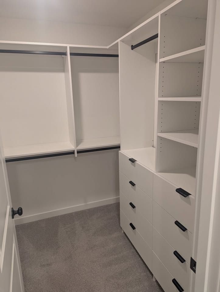 White closet, right of the door, with drawers and tall shelves