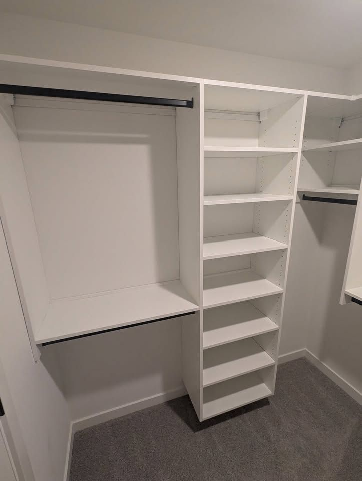 White closet, left wall, with a shelf stack and desk-height shelf